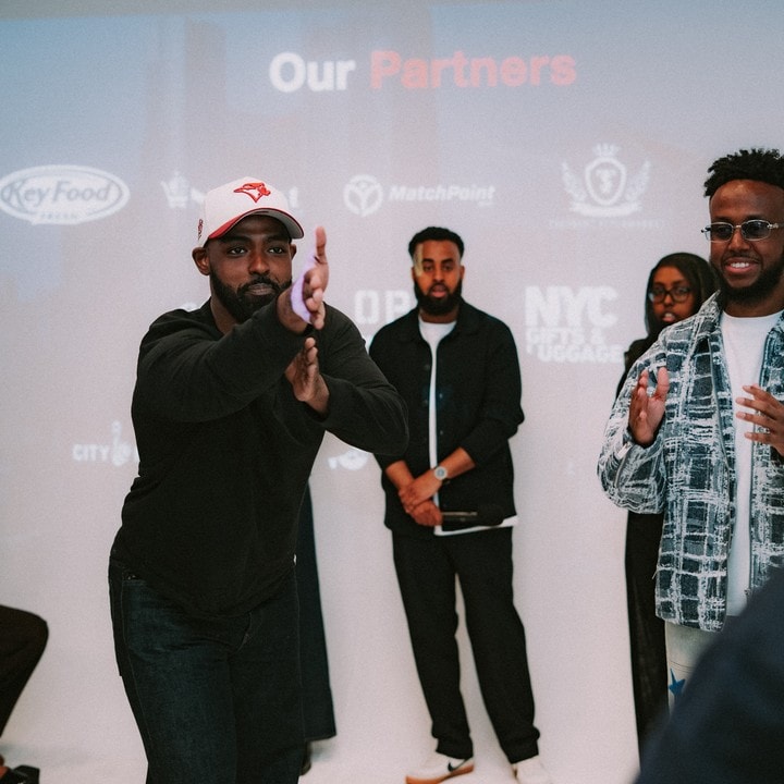 Hosts welcoming the room at a past event