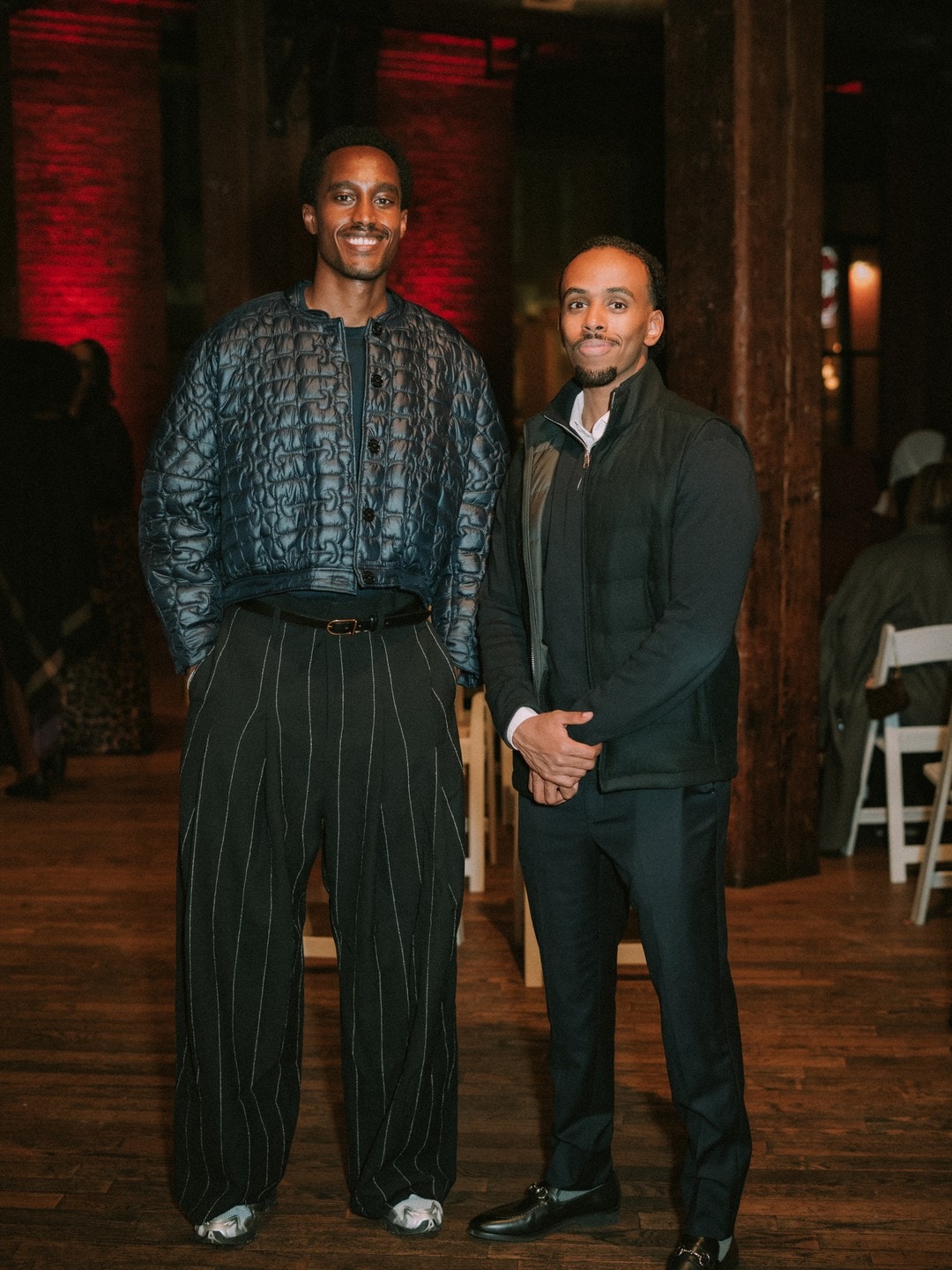 Two creators dressed sharp at a past event