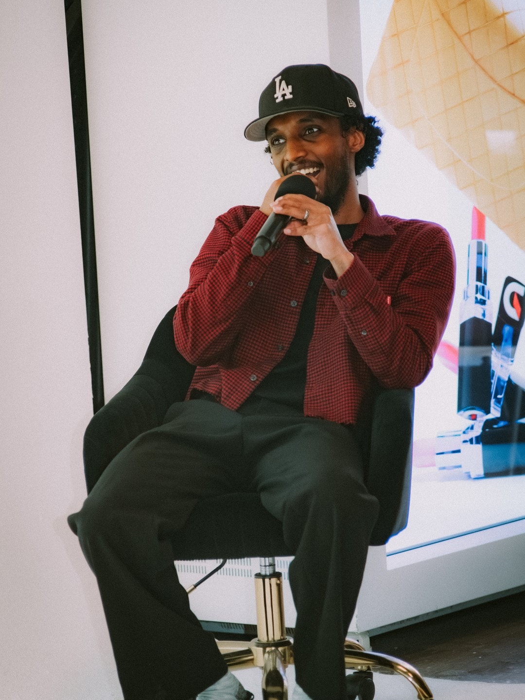 A panelist speaking into the mic on stage
